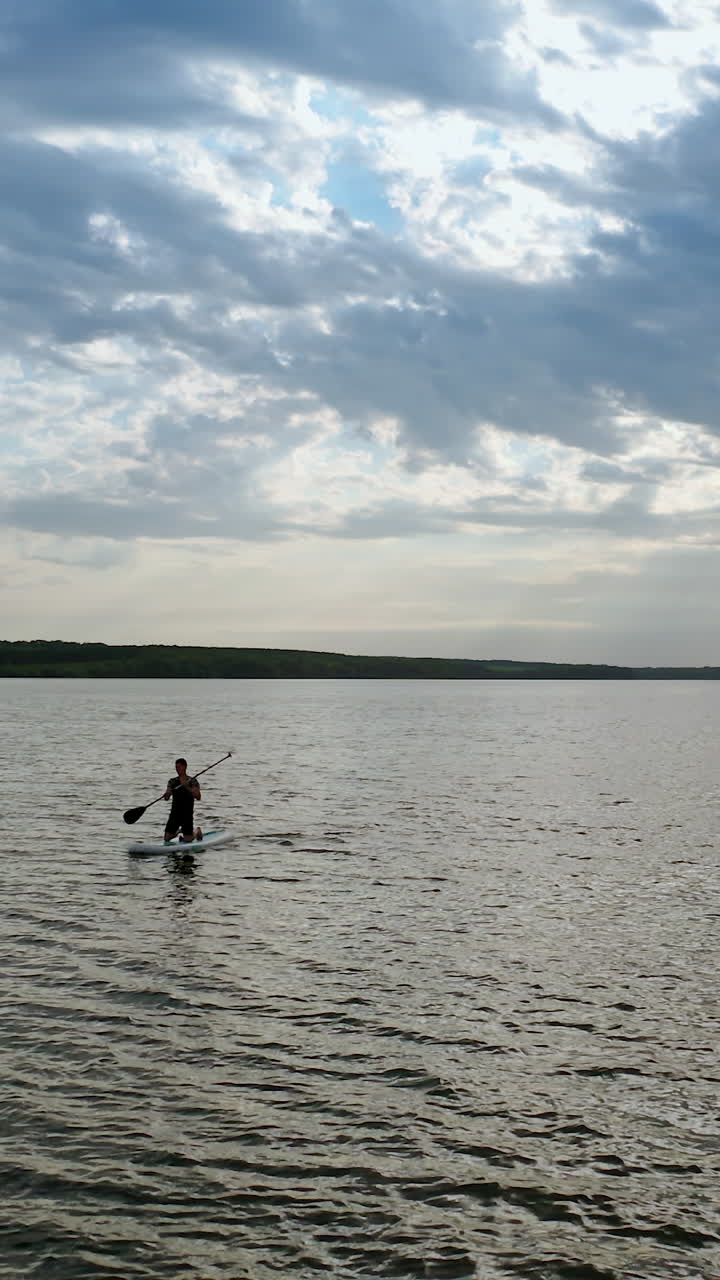 Couple relaxing on paddle sup board