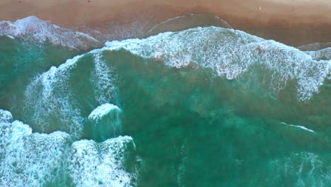 slowly moving to the right aerial top down drone shot of the beach and ocean riptide currents at bondi beach australia