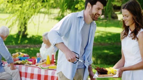 couple preparing food on barbecue