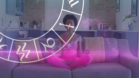 animation of horoscope zodiac wheel over biracial woman practicing yoga