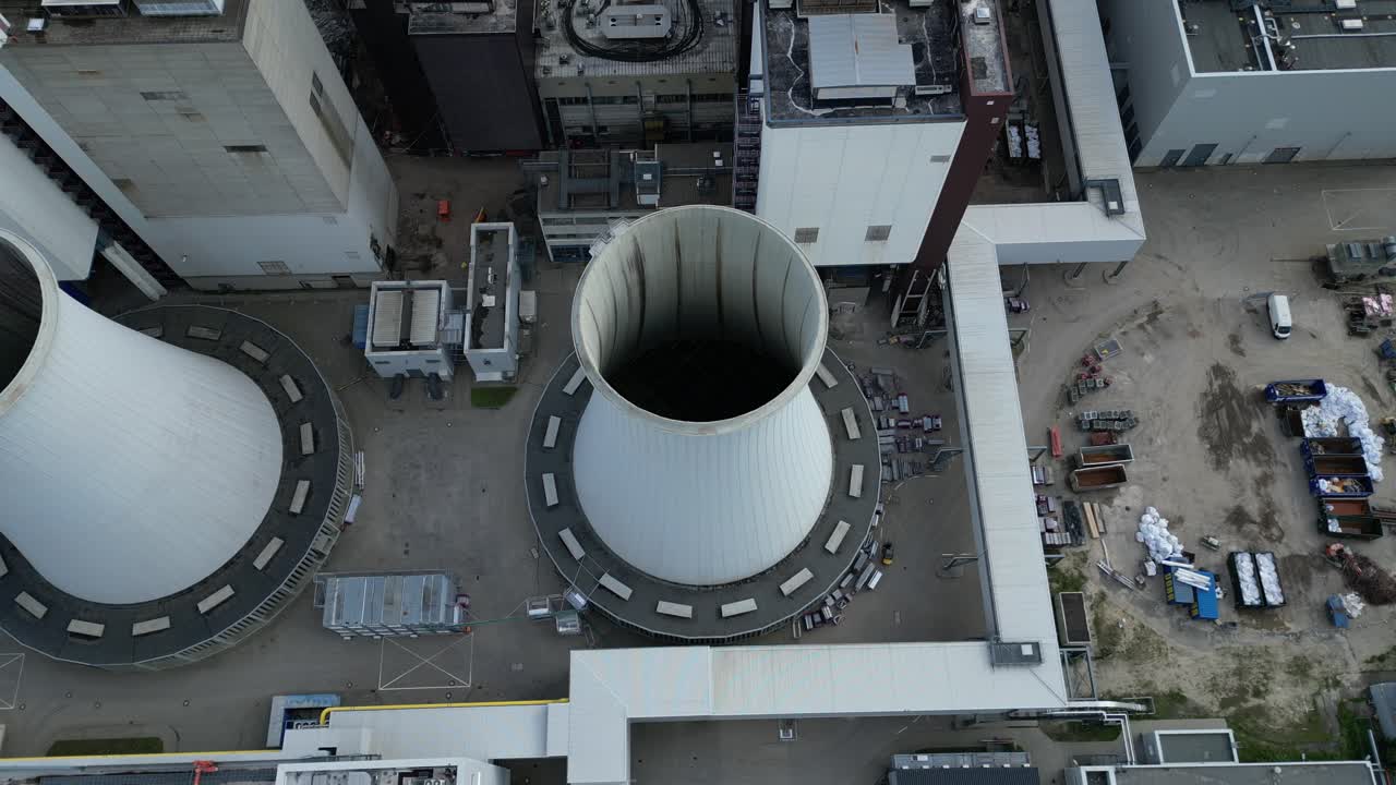 2 crane dismantling a power plant during a demolition process. Stunning aerial view flight drone camera pointing down