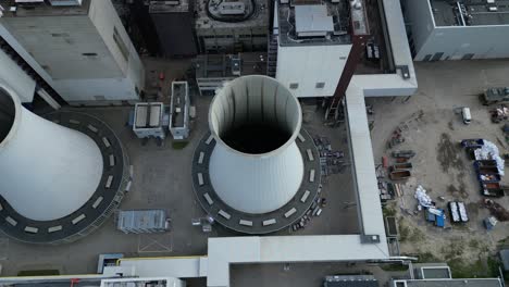 2 crane dismantling a power plant during a demolition process. stunning aerial view flight drone camera pointing down