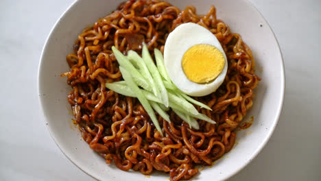 korean instant noodle with black bean sauce topped cucumber and boiled egg - korean food style