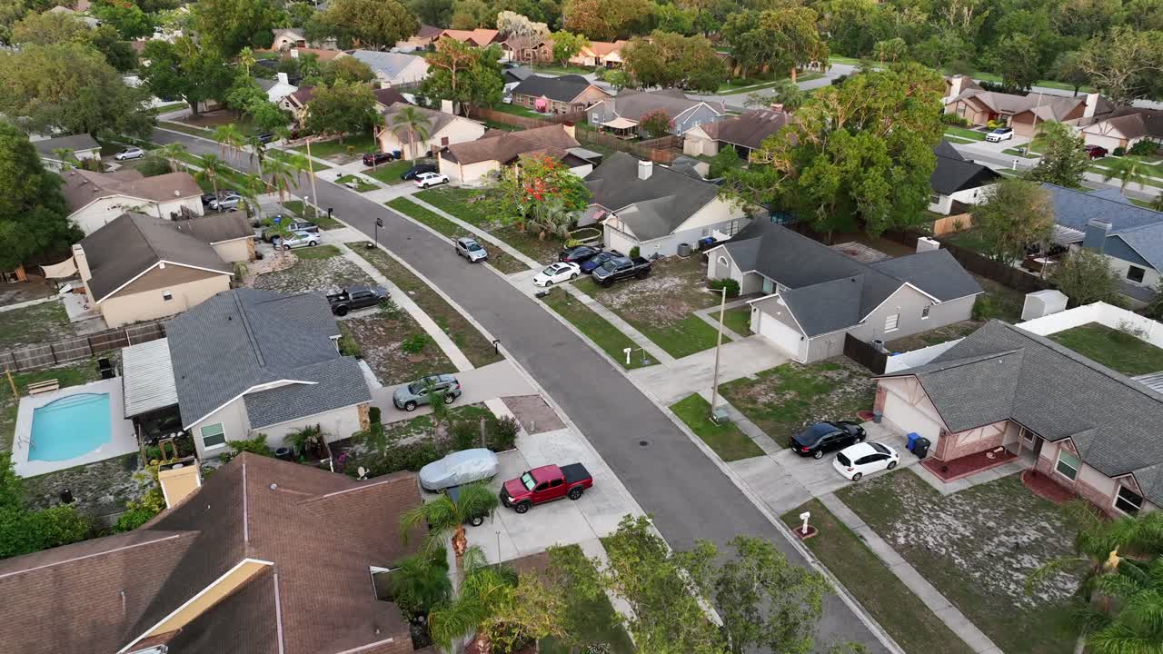 Noble suburb neighborhood with large single family homes, garage and swimming pool in garden. Aerial top down. Suburb district of Brandon, Florida, USA. Wide shot.