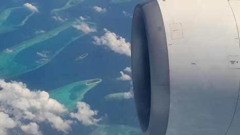 aerial top down view of emerald atolls of maldives from airplane