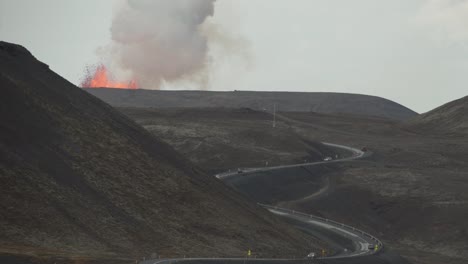 volcano eruption over winding mountain road iceland 2021