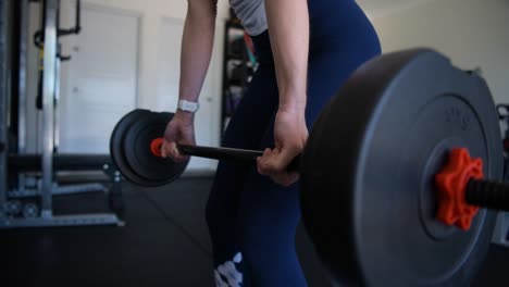 woman weightlifting in home gym