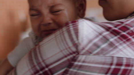 unhappy-baby-crying-on-mothers-shoulder-upset-infant-screaming-with-young-mom-calming-tired-child