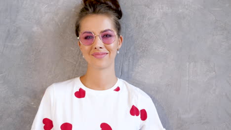 woman wearing pink sunglasses and heart t-shirt