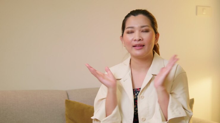Young adult woman explaining and interview video online communication with casual clothing and speaking in room