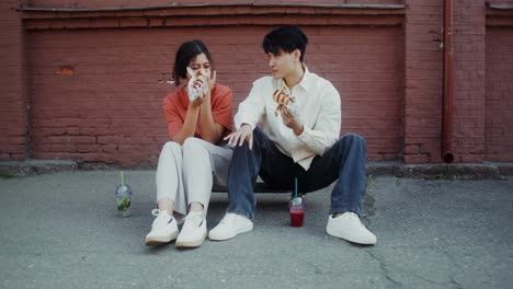 couple eating street food on skateboards