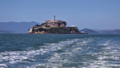 alcatraz island and former federal prison buildings, view from san francisco bay and ferry