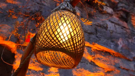 rustic wicker hanging lamp on stone wall