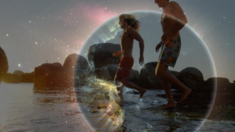 couple running through water on rocky shore at sunset, featuring cosmic sphere for tech marketing