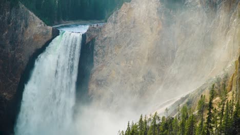 the grand canyon of yellowstone national park lower falls mist rises into the canyon in a medium closeup