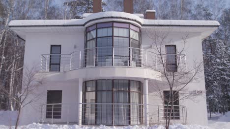 modern white house in snowy landscape