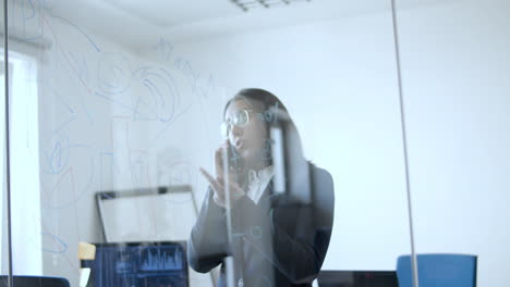 focused female manager talking on cell phone in her office