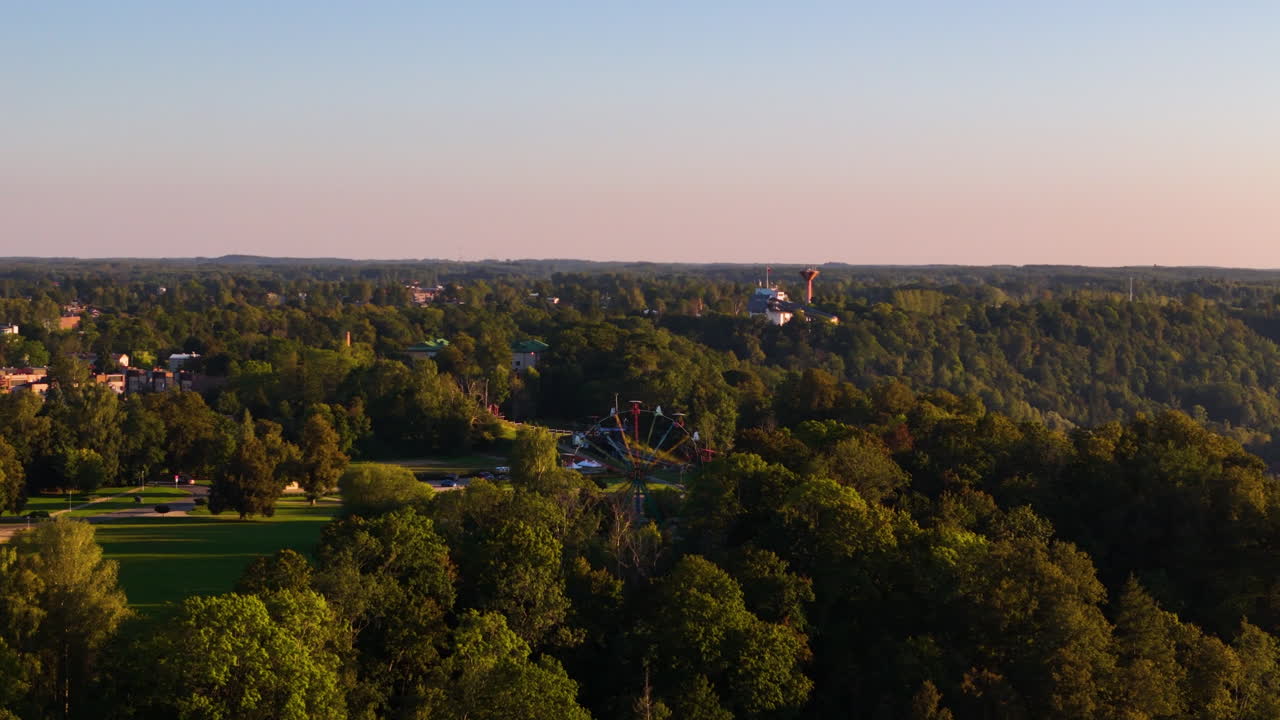 Popular Tourist Attractions At Festivity Square In Sigulda, Latvia. Slow Aerial Pan Across A Beautiful Sunset Horizon.