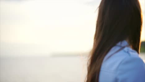 woman looking at sunset over river