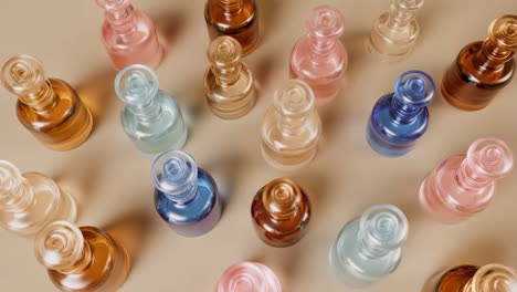 collection of colorful glass perfume bottles on a beige background