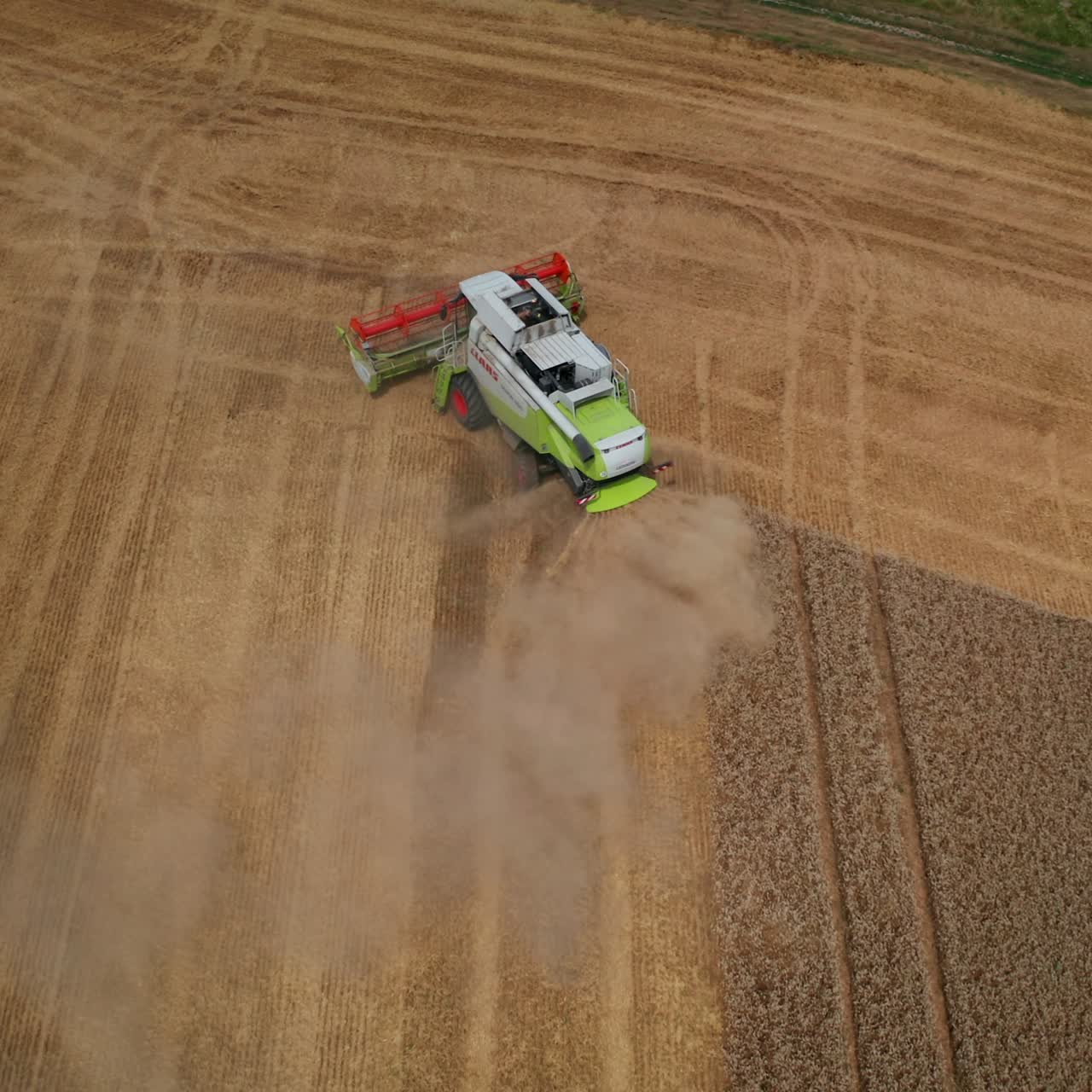 Powerful mowing machine finished cutting the row. Harvester makes a turn in the field. View from above