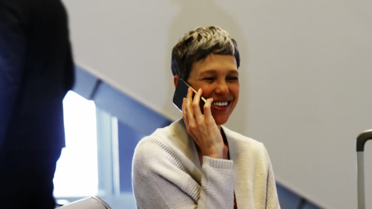 Woman talking on mobile phone in waiting area