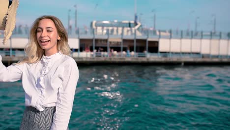 beautiful girl poses near bosphorus with view of galata bridge and istanbul