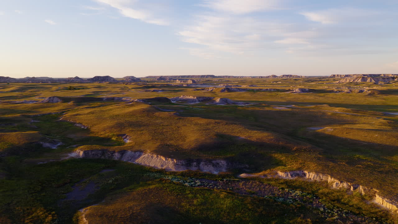 Glorious Sunset Over Rugged Badlands Peaks Captured in Aerial Flight