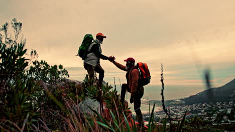 hikers helping each other on mountain top
