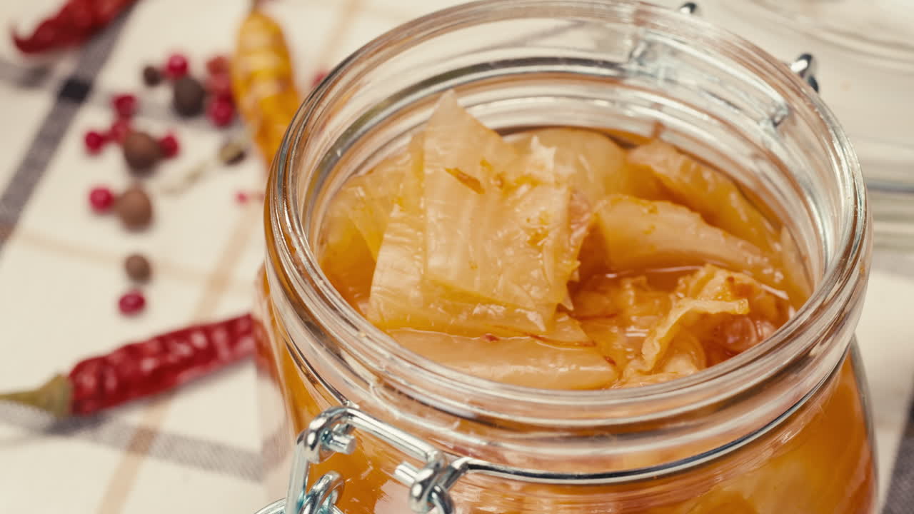 Close-up of fermented spicy cabbage kimchi with in can. Preservation of vegetables in glass jars. Fermentation preserved kimchi cabbage with spices macro. Asian cuisine.