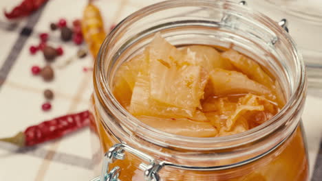 close-up of fermented spicy cabbage kimchi with in can. preservation of vegetables in glass jars. fermentation preserved kimchi cabbage with spices macro. asian cuisine.