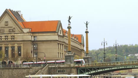 Building-and-bridge-near-river-with-two-crossing-trains