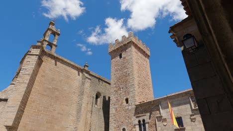 Low-angle-view-of-San-Mateo-Church-bell-tower-against-blue-sky,-Caceres