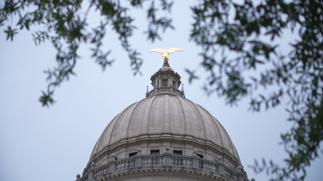 Rack focus in, close up: Stormy skies over the Mississippi State Capitol building. Jackson, MS.