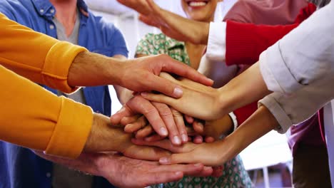 group of business executives with hand stack