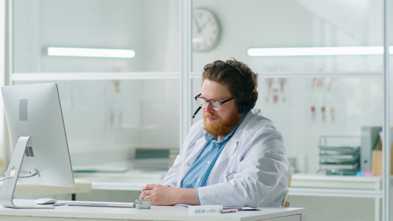 Male Doctor in Headset Consulting Remotely on Web Call