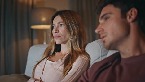 man hand switching channels holding tv remote at home closeup. couple resting