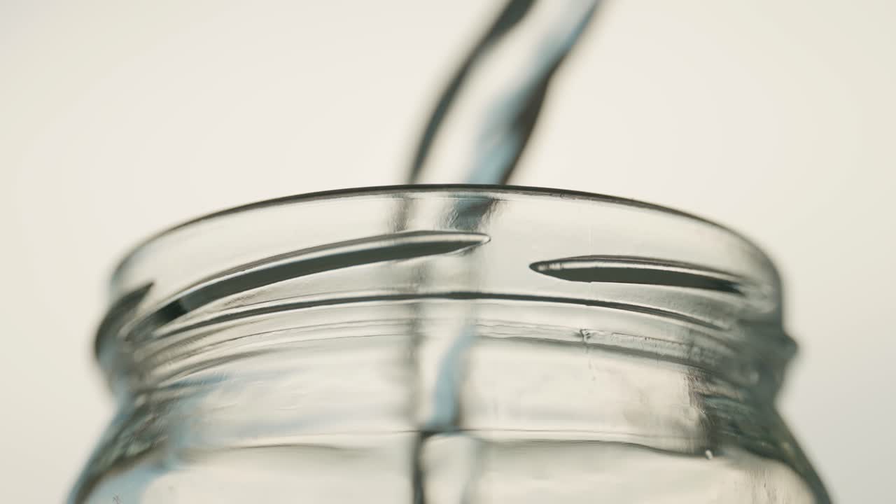 Slowmo of water big poured into a glass