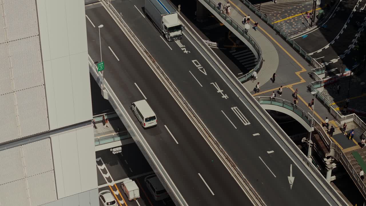 Aerial view of a highway with cars and pedestrians in an urban environment
