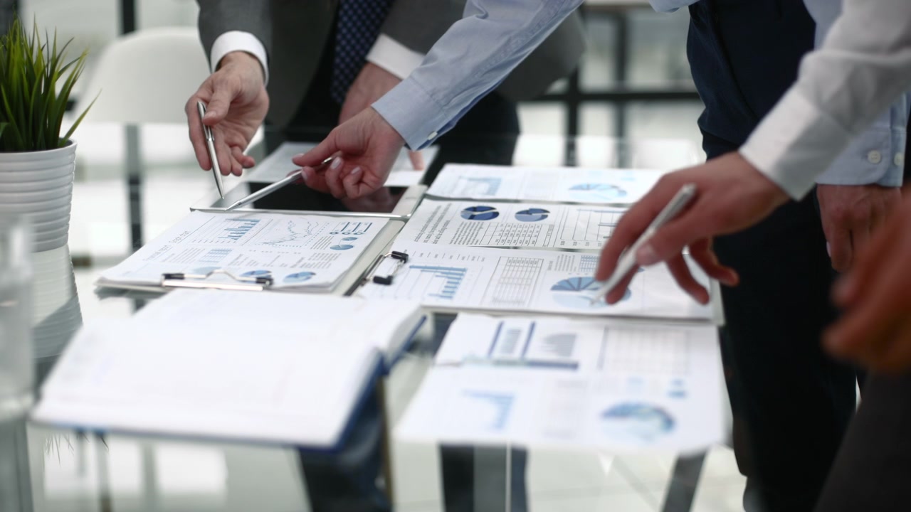 Business Professionals Analyzing Financial Data and Charts in an Office