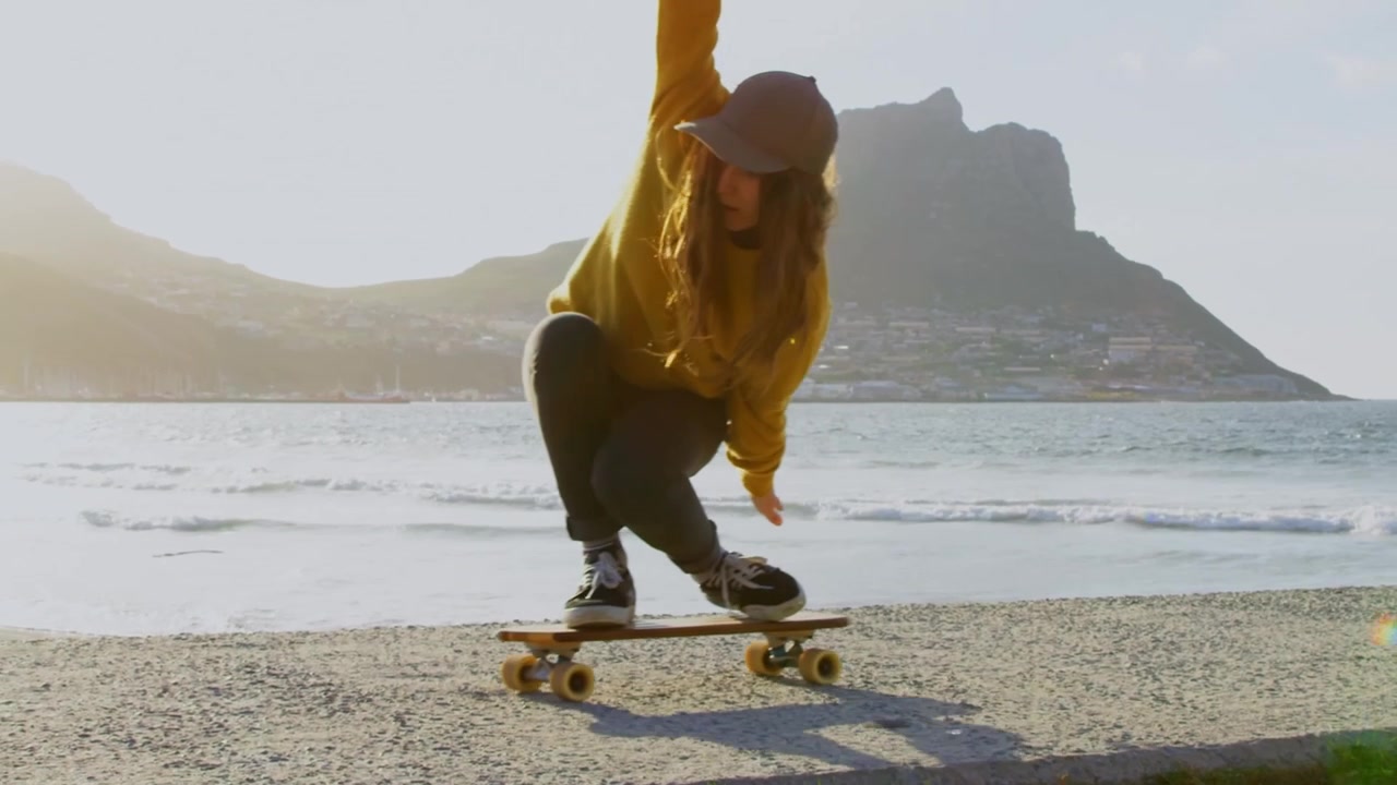 Young People Enjoying Surfing and Skateboarding at the Beach