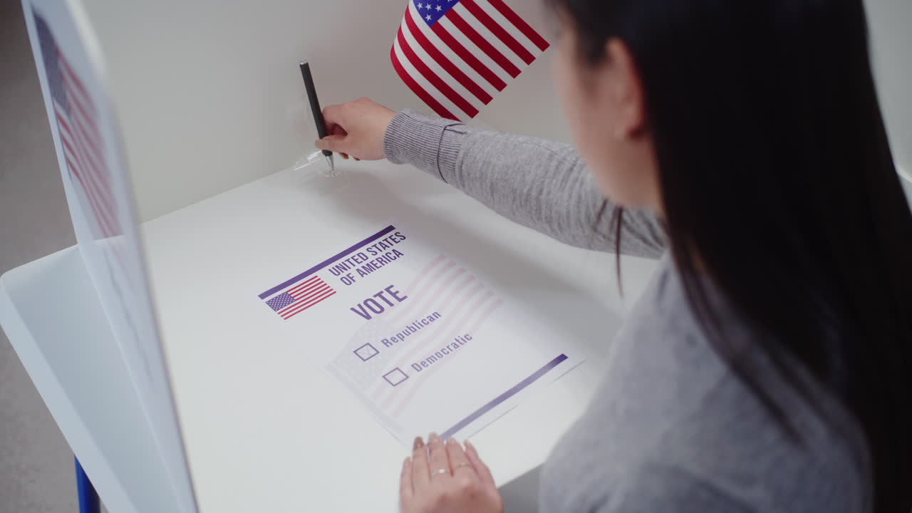 Asian Female Voter Votes for Republican Party in Paper Ballot Asian Female Voter Comes to Voting Booth at Polling Station Makes Choice and Votes for Republican Party in Paper Ballot American Citizen during National Election Day in the United States Civic Duty