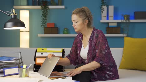 Home-office-worker-woman-finds-what-she-is-looking-for-on-the-table.