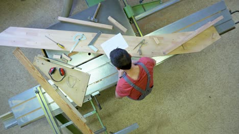 overhead view of carpenter working on wood project in workshop