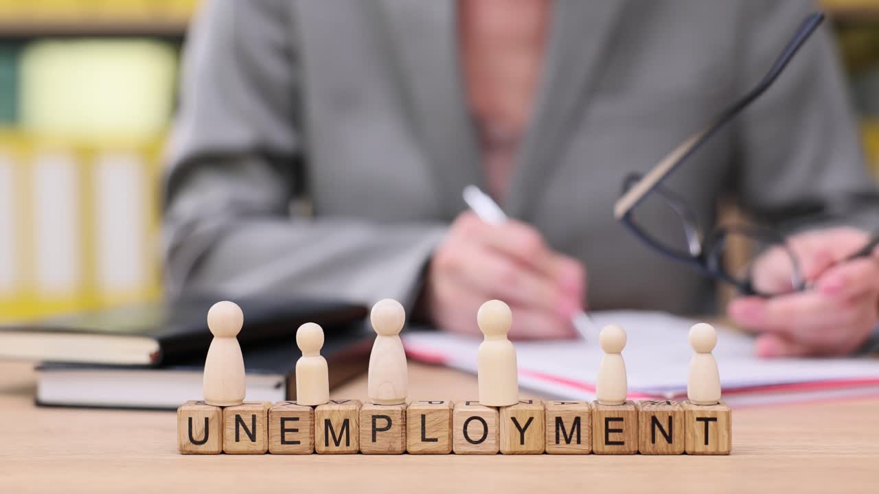 Unemployment concept with wooden blocks and miniature figures