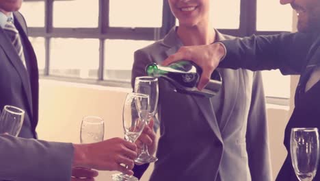business team toasting with champagne