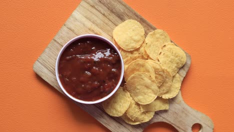 A-bowl-of-chips-and-salsa-on-table