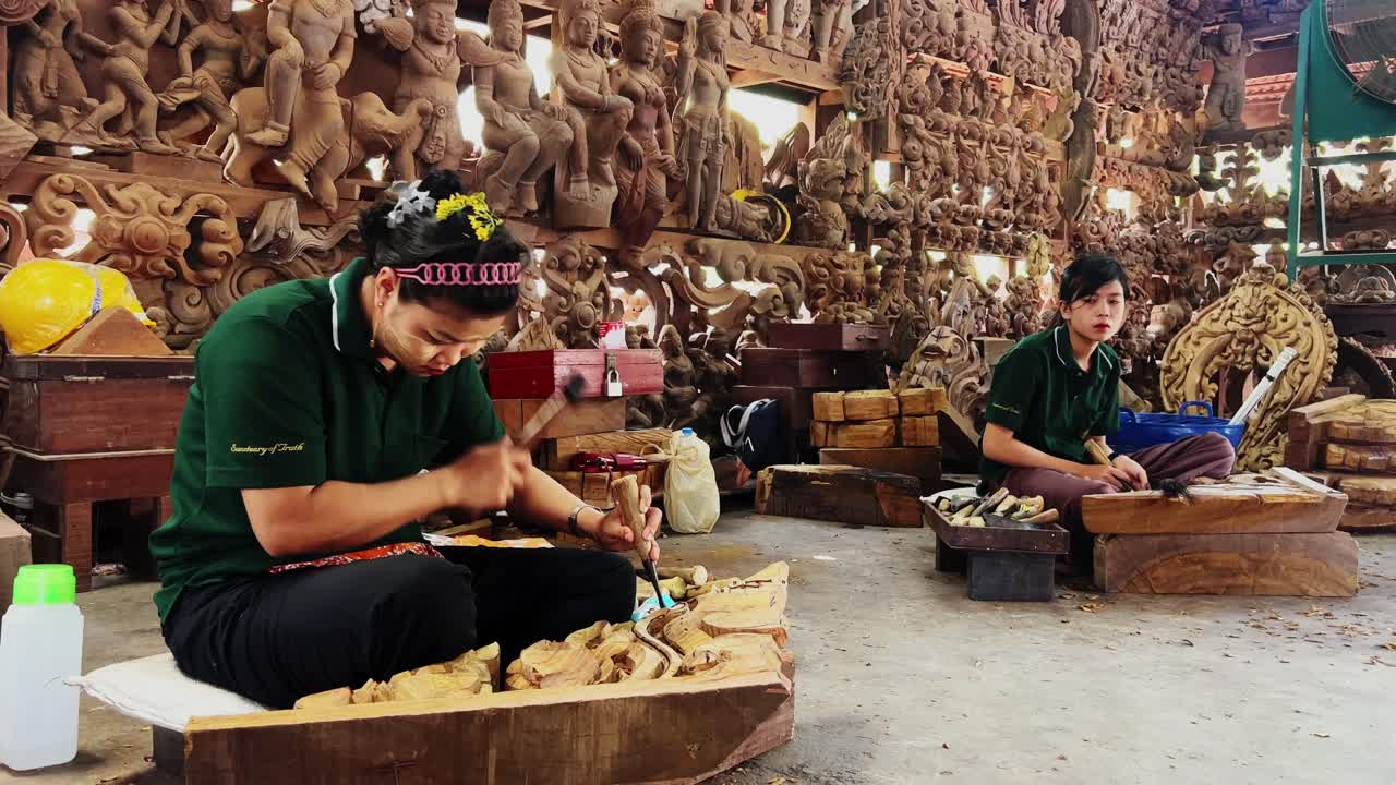 Two women sculpturing the temple piece in thailand 4k
