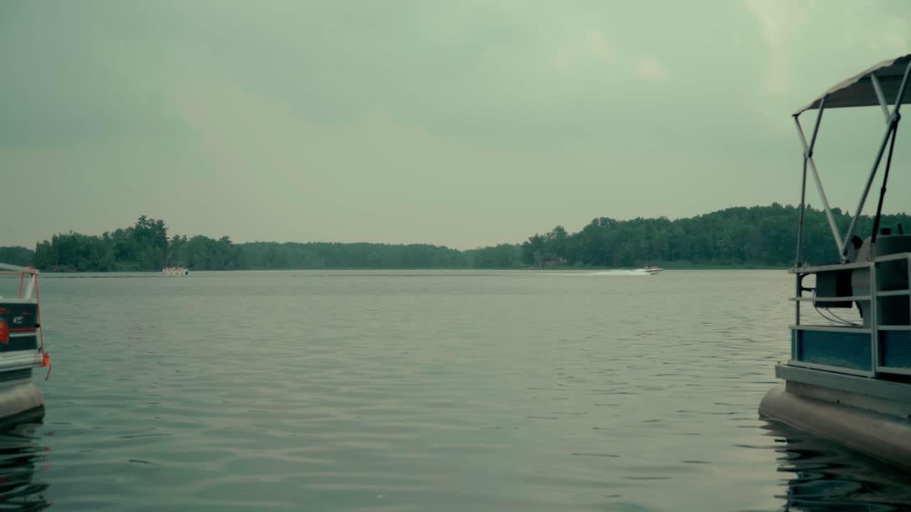 Motor boat passes by on a lake from left to right
