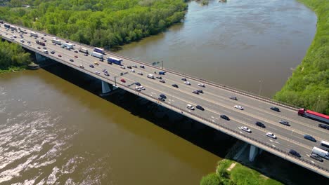 aerial view of traffic moving on a massive bridge over the vistula river in warsaw